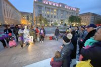 A group of people stand in solidarity at Freedom Plaza for World Day of Remembrance 2019.